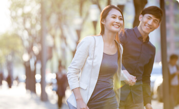 Single man and woman on a date while walking and holding hands