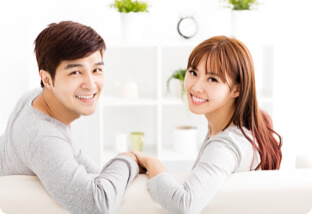 Asian couple smiling and holding hands