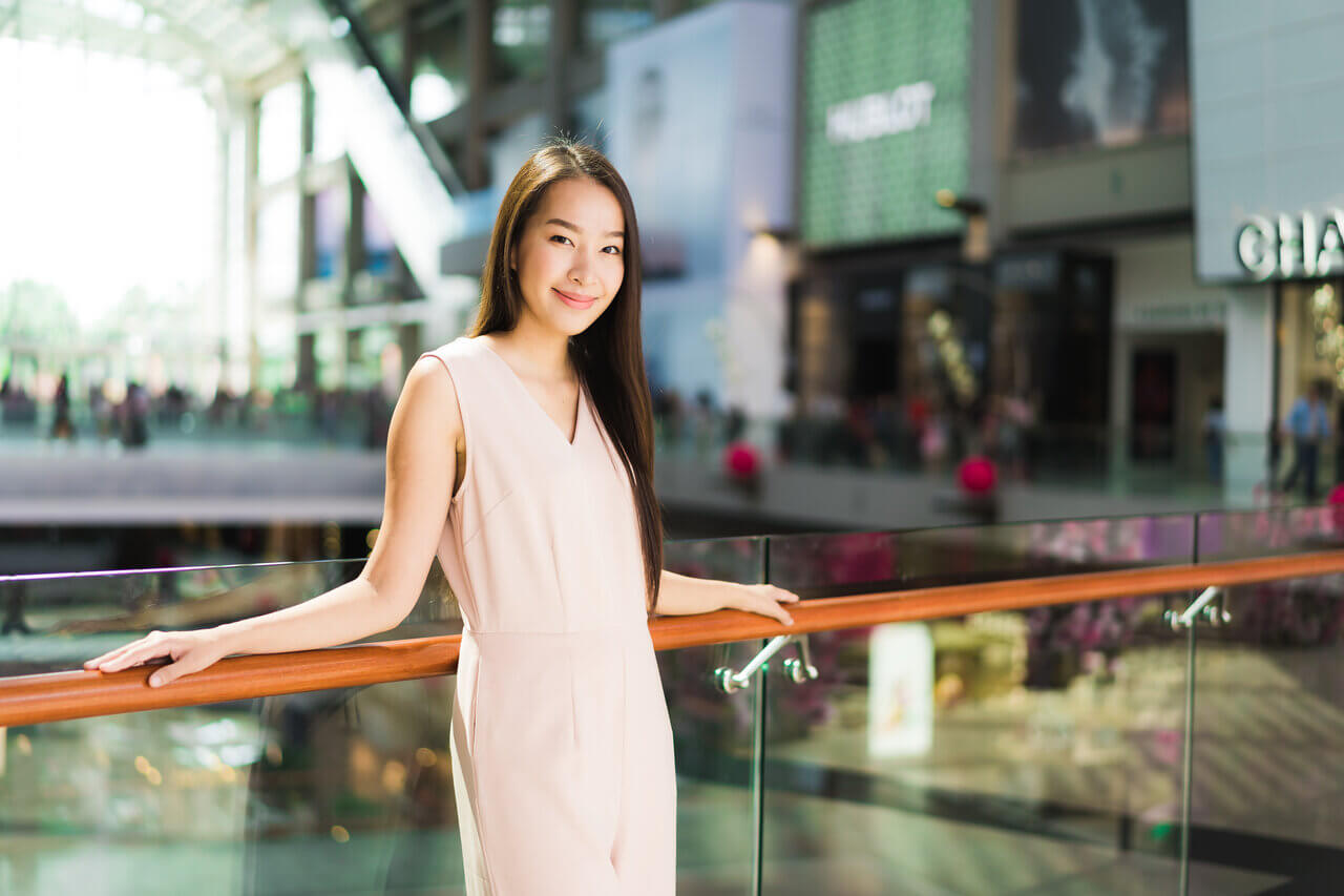 Gorgeous woman taking a photo in a mall