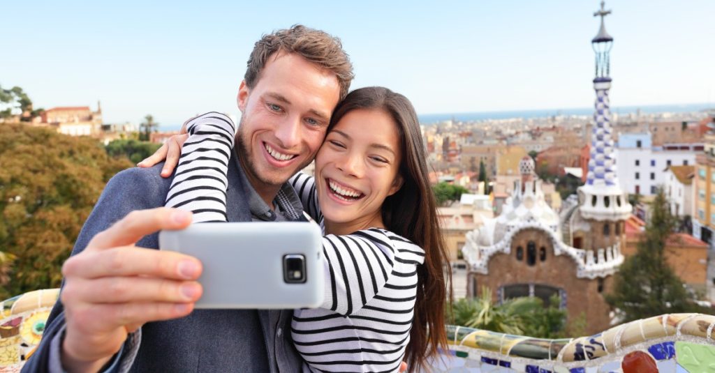 A couple hug and taking a selfie